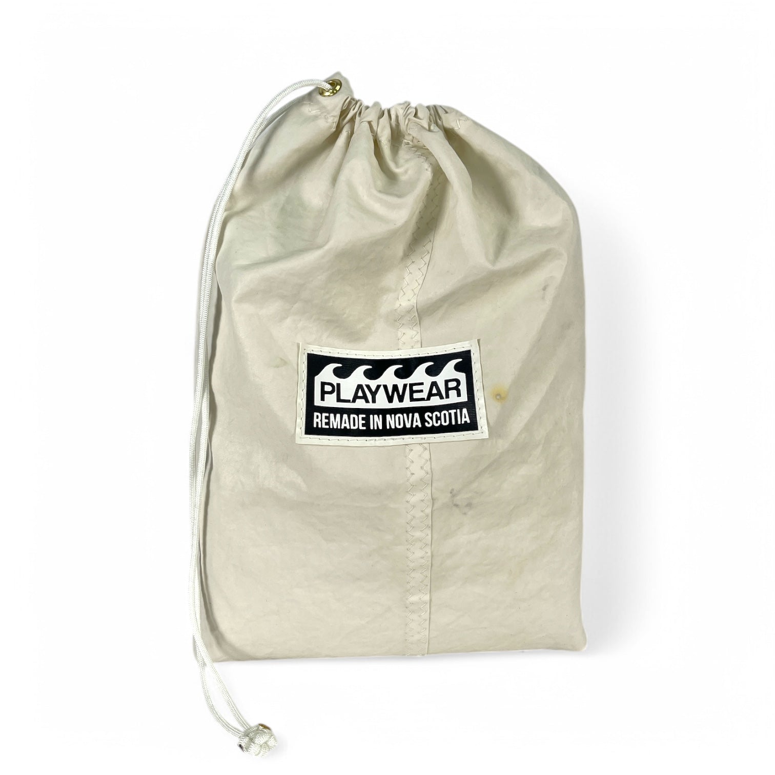 SUSTAINABLY MADE IN CANADA. UPCYCLED BY PLAYWEAR FROM REPURPOSED SAILS AND OTHER MATERIALS. COMPACT, PACKABLE, TRAVEL, BEACH BLANKET.