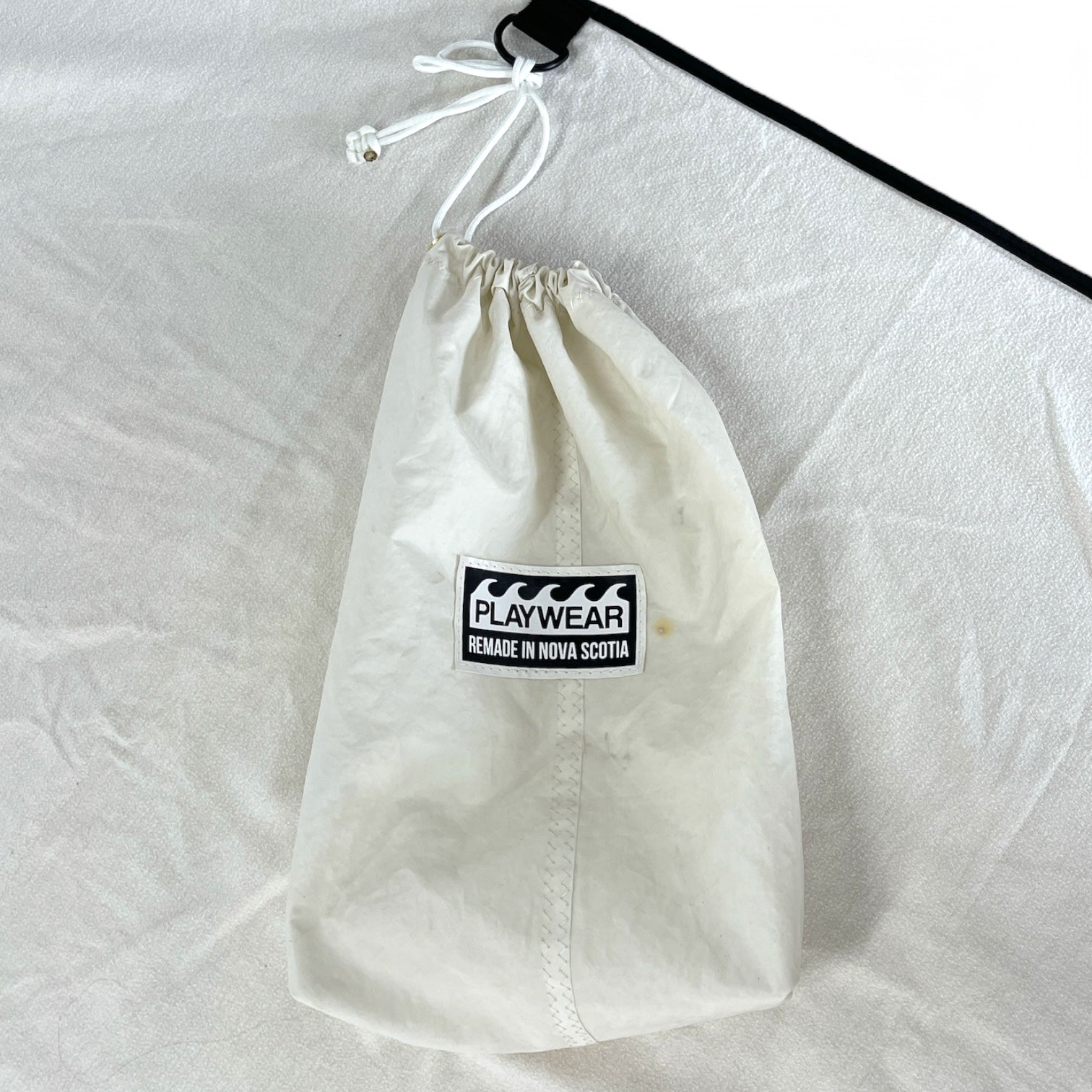 SUSTAINABLY MADE IN CANADA. UPCYCLED BY PLAYWEAR FROM REPURPOSED SAILS AND OTHER MATERIALS. COMPACT, PACKABLE, TRAVEL, BEACH BLANKET.