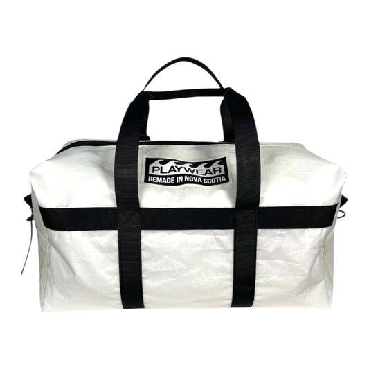 SUSTAINABLY MADE IN CANADA. UPCYCLED BY PLAYWEAR FROM REPURPOSED SAILS. MEDIUM DUFFEL BAG WITH OPTIONAL SHOULDER STRAP.