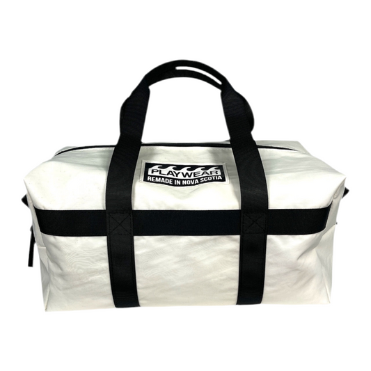 SUSTAINABLY MADE IN CANADA. UPCYCLED BY PLAYWEAR FROM REPURPOSED SAILS. SMALL DUFFEL BAG WITH OPTIONAL SHOULDER STRAP. 