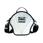 White playwear product with black straps on a white background