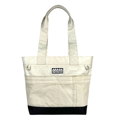 SUSTAINABLY MADE IN CANADA. UPCYCLED BY PLAYWEAR FROM REPURPOSED SAILS. SMALL TOTE BAG WITH OUTSIDE POCKETS.
