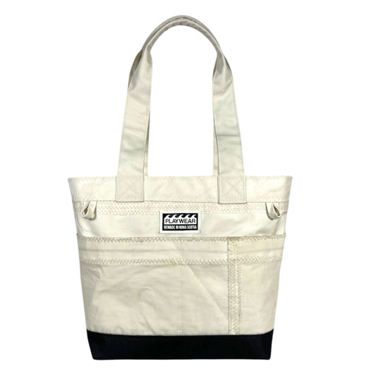 SUSTAINABLY MADE IN CANADA. UPCYCLED BY PLAYWEAR FROM REPURPOSED SAILS. SMALL TOTE BAG WITH OUTSIDE POCKETS.