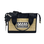 Black and beige bag with 'Playwear Remade in Nova Scotia' label on a white background
